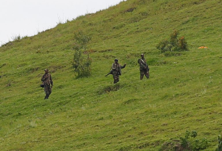   M23 rebel fighters are seen walking up a hill overlooking Goma, six kilometers from the center of the eastern Congo city, Monday Dec. 3, 2012. Rebels, who finally withdrew from this regional capital over the weekend, said they are waiting for a 48-hour deadline to expire on Monday afternoon, before deciding if they will take back the city. After a nearly two-week occupation, the M23 rebel group agreed to leave Goma on the condition that Congo's government enters into negotiations with them by 2 p.m. Monday. (AP Photo/Jerome Delay)  