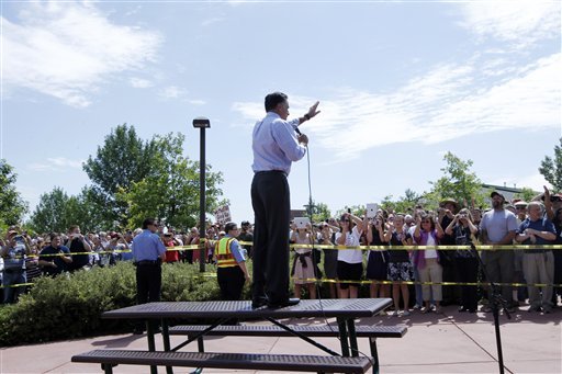 Republican presidential candidate Mitt Romney stands on a table as he addresses an overflow crowd at the Jefferson County Fairgrounds in Golden, Colo. (AP Photo)
