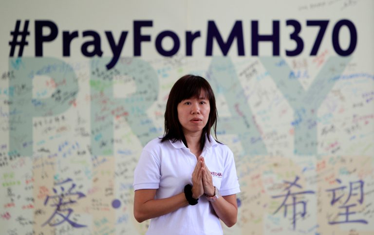 FILE - In this April 13, 2014 file photo, a member of Kechara Buddhist organization offers prayers for passengers onboard the missing Malaysia Airlines Flight 370 at Kechara Forest Retreat in Bentong, outside Kuala Lumpur, Malaysia. The hunt for Malaysia Airlines Flight 370 resumed Monday, Oct. 6, 2014 in a desolate stretch of the Indian Ocean, more than six months after the jet vanished. (AP Photo/Lai Seng Sin, File)