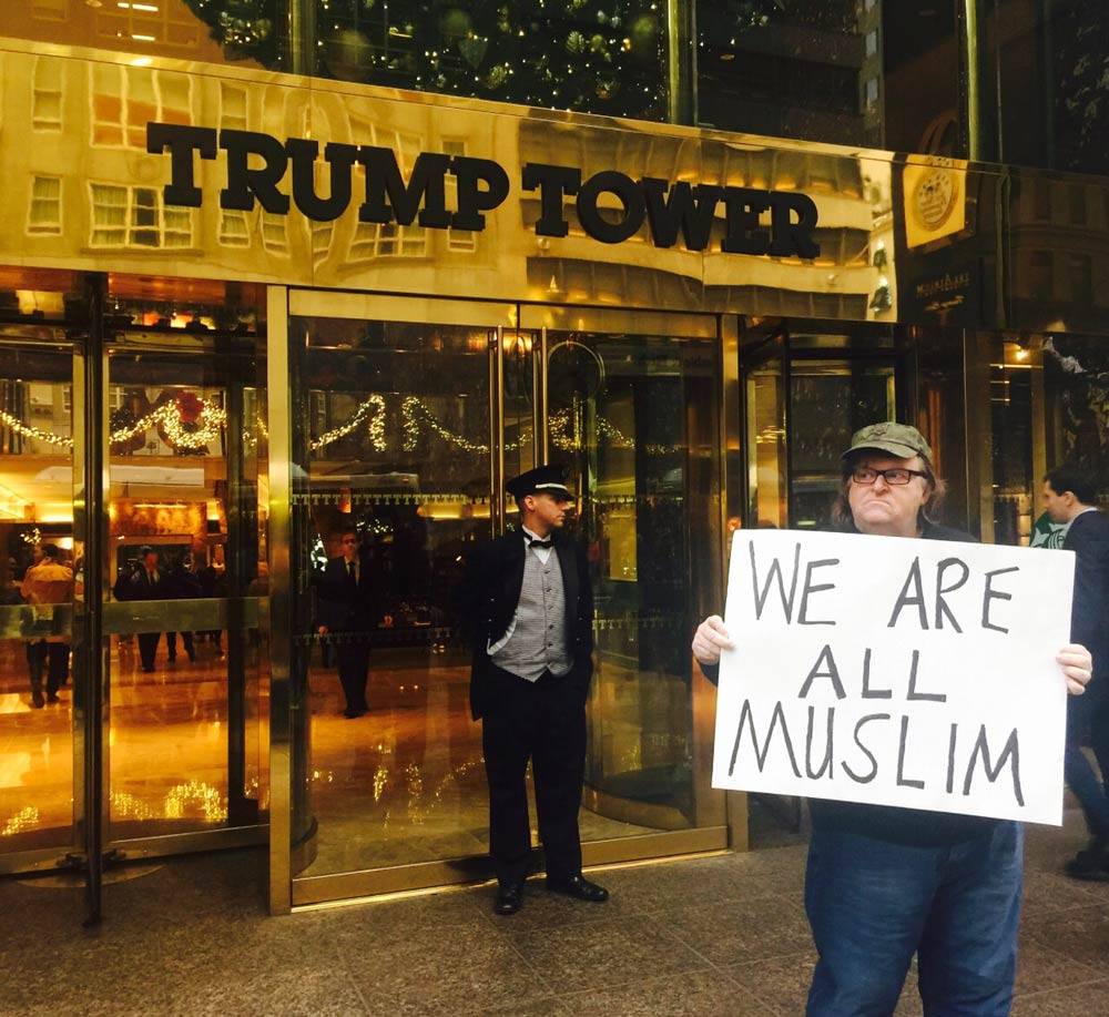 Michael Moore stands in front of Trump Tower with provocative sign