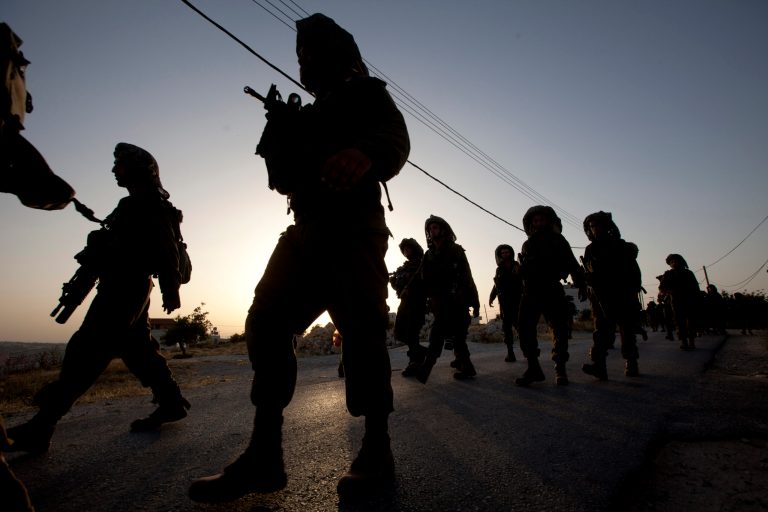 Israeli soldiers patrol during a military operation to search for three missing teenagers outside the West Bank city of Hebron, Monday, June 16, 2014. Israeli security forces searched the West Bank, looking for three missing teenagers, including an American, who they fear have been abducted by Palestinian militants. (AP Photo/Majdi Mohammed)