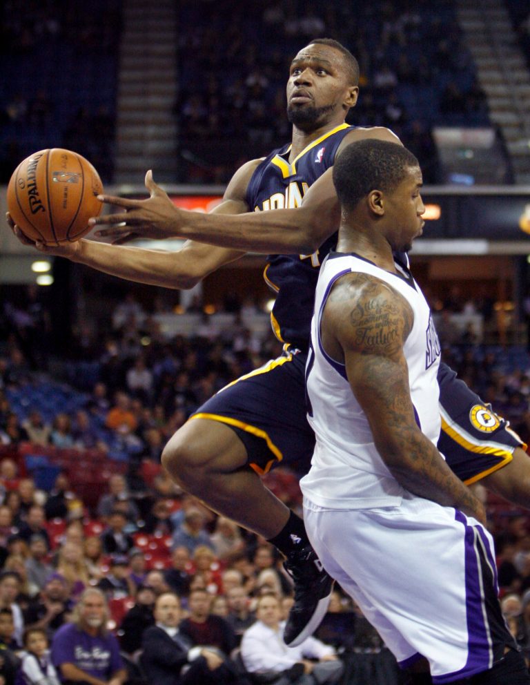   Indiana Pacers guard Sam Young, left, drives to the basket past Sacramento Kings defender Thomas Robinson during the first half of an NBA basketball game in Sacramento, Calif., on Friday, Nov. 30, 2012. (AP Photo/Steve Yeater)  