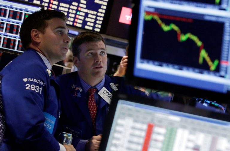 FILE - In this Wednesday, Oct. 15, 2014, file photo, specialists Robert Tuccillo, left, and Frank Masiello work on the floor of the New York Stock Exchange. The market took investors on a wild ride this week. In fact, at one point on Wednesday, the Dow Jones industrial average plummeted 460 points, but pared most of those losses by the end of the trading day. Investors are now wondering what's next for the market. (AP Photo/Richard Drew, File)