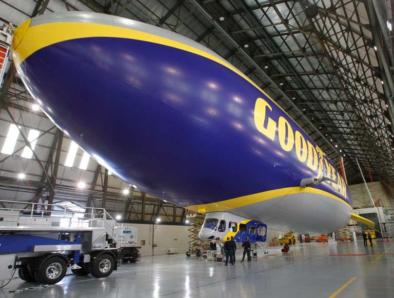 This photo taken Feb. 28, 2014, shows Zeppelin and Goodyear crews work together in prepping Goodyear's new zeppelin in the Wingfoot Lake Hangar for its debut in Suffield Township, Ohio.