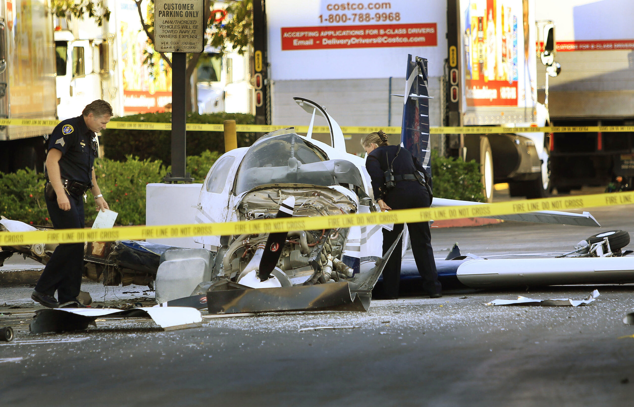 Passenger dies, pilot hurt in parking lot crash