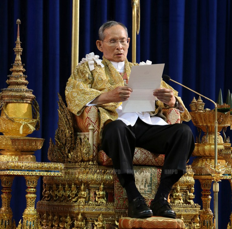 FILE - In this Dec. 5, 2013 file photo released by Thailand's Royal Household Bureau, Thailand's King Bhumibol Adulyadej reads a statement at Klai Kangwon Palace during a ceremony in celebration of his 86th birthday in Prachuap Khiri Khan province, Thailand. The 86-year-old king was admitted to a Bangkok hospital and being treated for a fever that doctors believe was caused by an infection, the palace said Saturday, Oct. 4, 2014. The king arrived at Siriraj Hospital late Friday night from his seaside palace 120 miles (200 kilometers) southwest of the capital. (AP Photo/Royal Household Bureau, File)