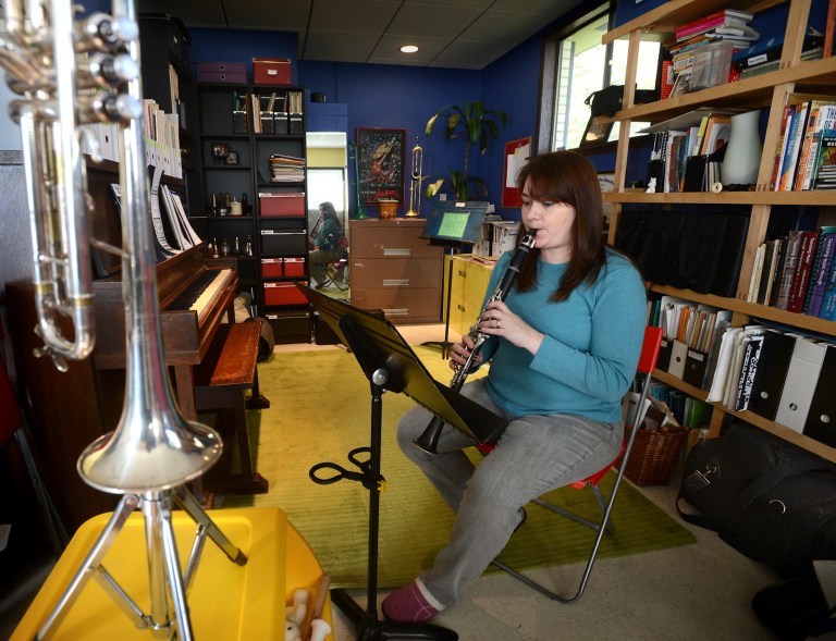 May 6, 2013 -- Cindy Renander practices the clarinet in her converted garage. (SHNS photo by Lui Kit Wong / The News Tribune)
