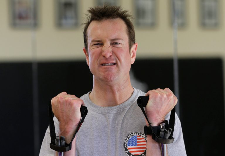Race car driver Kurt Busch works out at a gym in Ellicott City, Md. On Memorial Day weekend, NASCAR's bad boy is trying to own the title of baddest man on the track by pulling off racing's version of an IronMan triathlon. In a single day, he'll try and race in the Indianapolis 500 and the Coca-Cola 600, with a race or two against the clock thrown in.(AP Photo/Patrick Semansky)