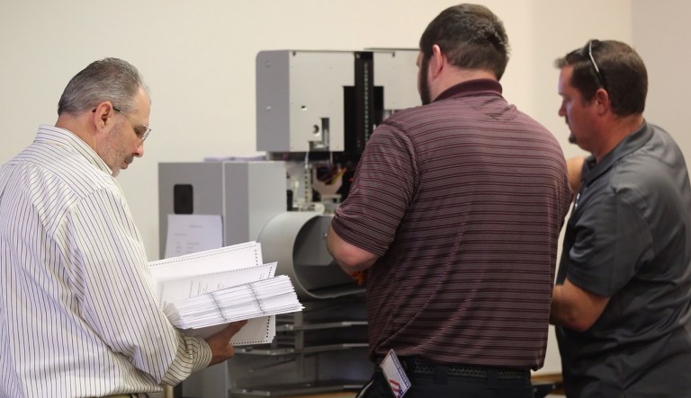 Officials used a high-speed machine to recount results from the 94th District House of Delegates race. Democratic challenger Shelly Simonds requested the recount and eventually beat incumbent Republican Del. David Yancey by just one vote. (Joe Fudge/The Daily Press via AP)
