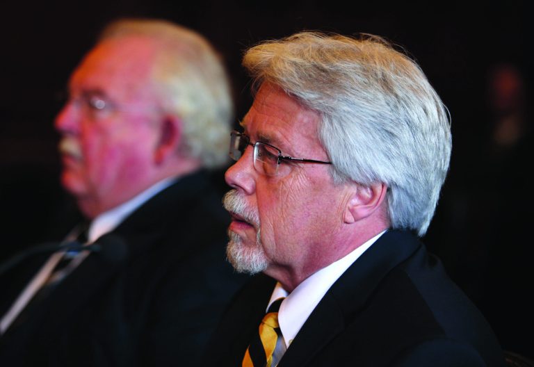Mark Strong Sr., right, sits with his attorney Dan Lilley, left, during his arraignment Tuesday, Oct. 9, 2012 in Portland, Maine on 59 charges, including promotion of prostitution and violation of privacy in connection with a Kennebunk Zumba dance studio. Strong Jr. entered a plea of not guilty. (AP Photo/Joel Page)