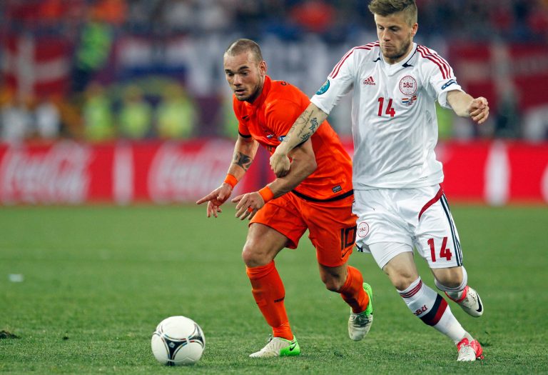   Wesley Sneijder from the Netherlands, left, and Denmark's Lasse Schone fight for possession during the Euro 2012 soccer championship Group B match between the Netherlands and Denmark in Kharkiv , Ukraine, Saturday, June 9, 2012. (AP Photo/Matthias Schrader)  