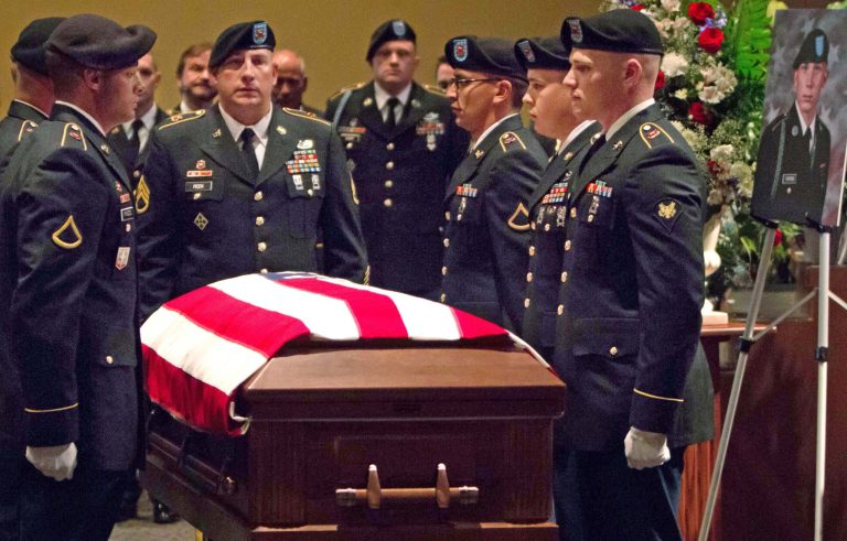 An honor guard surrounds the casket bearing U.S. Army Pvt. Aaron Toppen, during funeral services at Parkview Christian Church Tuesday June 24, 2014, in Orland Park, Ill. The 19-year-old soldier from suburban Chicago who was killed in Afghanistan was laid to rest Tuesday after hundreds of mourners attended his funeral. Toppen was one of five American service members killed this month when a U.S. airstrike was called to help defend against a Taliban ambush. (AP Photo/Courtesy of Parkview Christian Church,Scott Josephs)