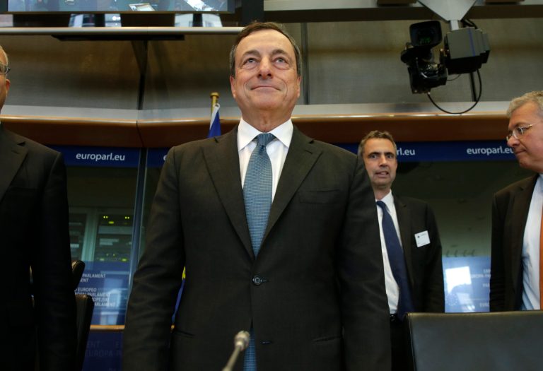 President of the European Central Bank Mario Draghi smiles before he takes his seat to address the Committee on Economic and Monetary Affairs, at the European Parliament building, in Brussels on Monday, Sept. 22, 2014. (AP Photo/Yves Logghe)