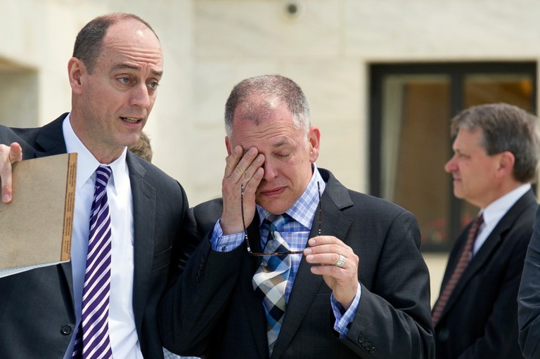 Plaintiff James Obergefell of Ohio wipes his eyes after exiting the Supreme Court in Washington, Tuesday, April 28, 2015. (AP Photo/Cliff Owen)