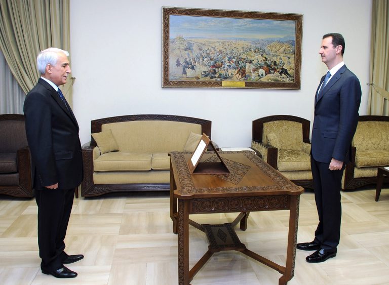 In this photo released by the Syrian official news agency SANA, taken on Monday, Sept. 17, 2012, Syrian president Bashar Assad, right, receives Raqqa Governor Hassan Jalali, left, after he was appointed governor, in Damascus, Syria. Opposition fighters captured Jalali after clashes overnight near the governor's office in the provincial capital, also named Raqqa. Activists said he is one of the highest-ranking officials to fall into rebel hands since the Syrian crisis began nearly two years ago. (AP Photo/SANA)