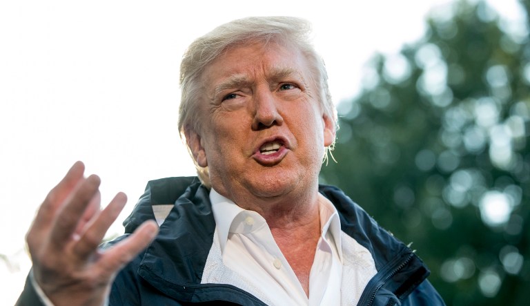 President Donald Trump talks to reporters as he walks to board Marine One on the South Lawn of the White House in Washington, Tuesday, Oct. 3, 2017, for a short trip to Andrews Air Force Base, Md. and then on to Puerto Rico. (AP Photo/Andrew Harnik)