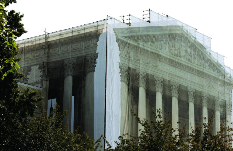 Workers cover the U.S. Supreme Court building in Washington Thursday, Sept. 27, 2012, with a protective scrim, as work continues on the facade. The Supreme Court is embarking on a new term beginning Monday that could be as consequential as the last one with the prospect for major rulings about affirmative action, gay marriage and voting rights. (AP Photo/Alex Brandon)
