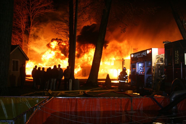   A fire burns at the historic Michillinda Lodge on western Michigan's Lake Michigan shoreline in Fruitland Township, Mich., early Sunday, Dec. 2, 2012. Norton Shores fire Chief Robert Gagnon says five people were staying in the lodge when the fire broke out, and all escaped without injury, according to reports from The Muskegon Chronicle-MLive Media Group. (AP Photo/The Muskegon Chronicle-MLive Media Group, LIsa Medendorp)  
