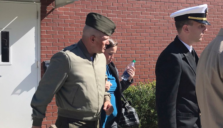 In this Tuesday, Oct., 31, 2017 photo, U.S. Marine Gunnery Sgt. Joseph A. Felix, his wife, and his lawyers exit a courtroom after testimony at Camp Lejeune, N.C. Military prosecutors say the former Marine Corps drill instructor facing court-martial on charges including cruelty and maltreatment was 