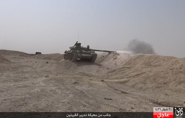 An Islamic State militant tank fires during a battle against Syrian government forces, in the town of Qaryatain southwest of Palmyra, central Syria. (Rased News Network a Facebook page affiliated with Islamic State militants via AP)