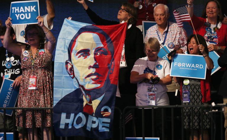 CHARLOTTE, NC - SEPTEMBER 06:  People cheer as Democratic presidential candidate, U.S. President Barack Obama speaks on stage as he accepts the nomination for president during the final day of the Democratic National Convention at Time Warner Cable Arena on September 6, 2012 in Charlotte, North Carolina.  (Photo by Alex Wong/Getty Images)