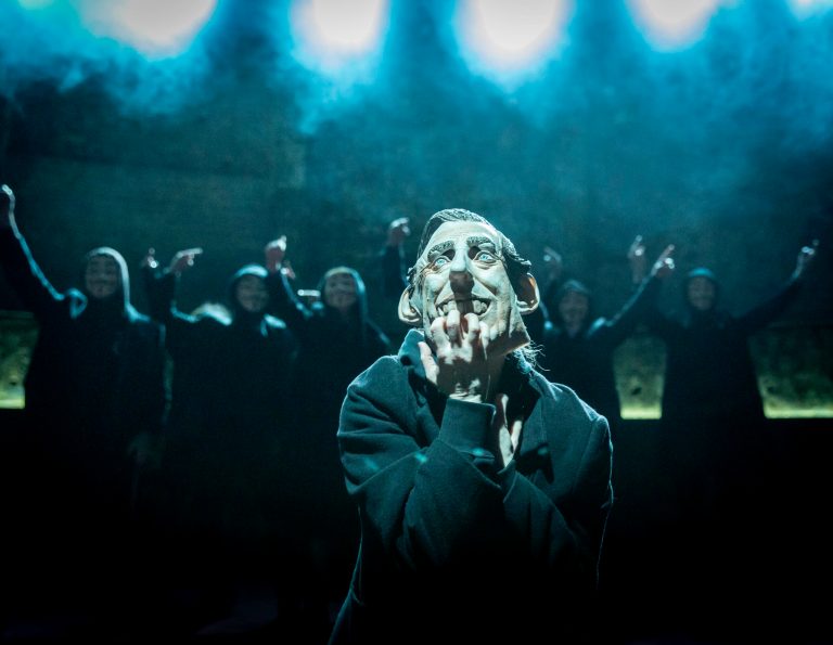 In this undated handout photo provided by the Almeida Theatre on Friday, April 11, 2014, actress Katie Brayben is seen wearing a mask that depicts Britain's Prince Charles during a scene from the play 'King Charles III' at the Almeida Theatre in London. A new play about Britain's future king is getting rave reviews. Once it would have been theatrical treason. 