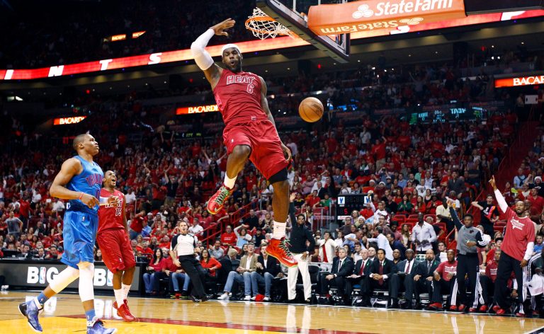   Miami Heat's LeBron James (6) dunks as Oklahoma City Thunder's Russell Westbrook (0) and Heat's Mario Chalmers (15) watch during the first half of an NBA basketball game, Tuesday, Dec. 25, 2012, in Miami. (AP Photo/J Pat Carter)  