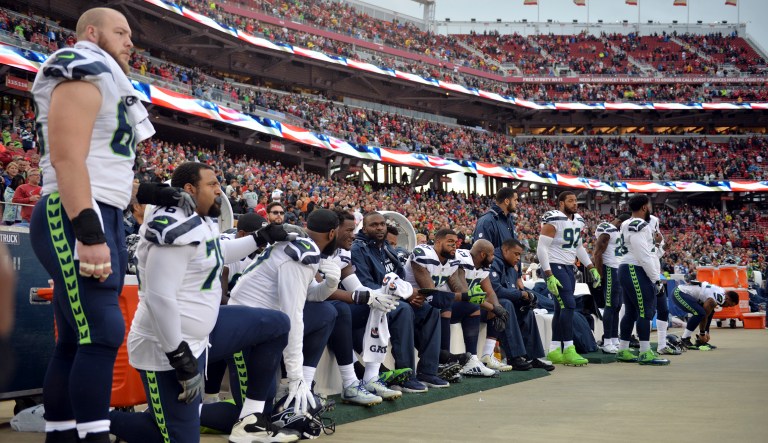 NFL players kneel during the playing of the national anthem before a football game in California. President Trump tweeted Tuesday, 