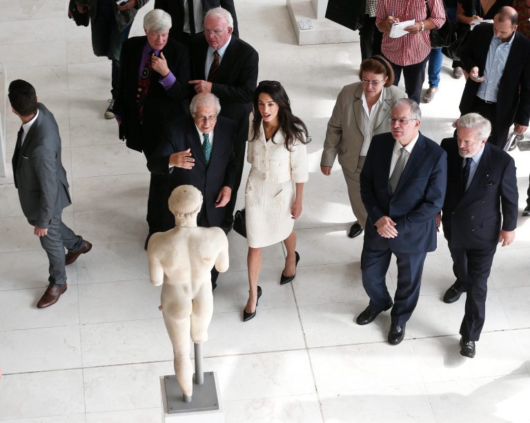 Lawyer Amal Clooney, center, is guided by the Director of the Acropolis museum Dimitris Pantermalis, left, during a visit at the Parthenon hall inside the Acropolis museum in Athens Wednesday Oct. 15, 2014. Lawyers Geoffrey Robertson, Norman Palmer and Amal Clooney arrived Monday to Greece on a four-day visit to meet government officials, including Prime Minister Antonis Samaras, and advise on Greece's quest to have the Parthenon Marbles returned to Athens. (AP Photo/Yorgos Karahalis, Pool)