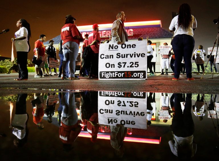 Protesters gather outside a Burger King in College Park, Ga., restaurant during a demonstration by fast-food workers and activists calling for the federal minimum wage to be raised to $15. (AP Photo/David Goldman)