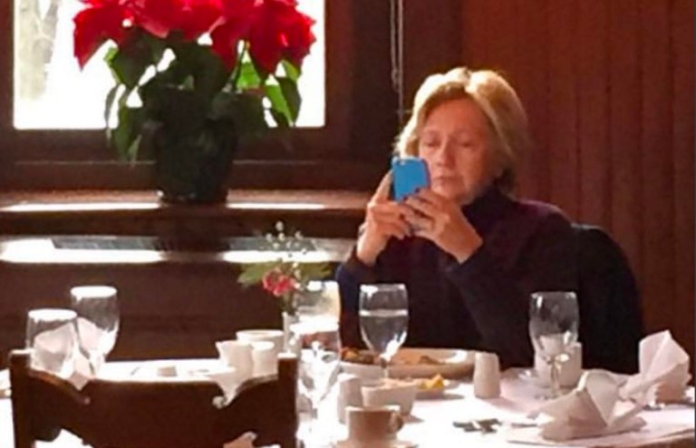Hillary Clinton was snapped at breakfast looking at her phone at the Mohonk Mountain House in Upstate New York. (Carolyn Ryan via Mike Smith, Twitter)