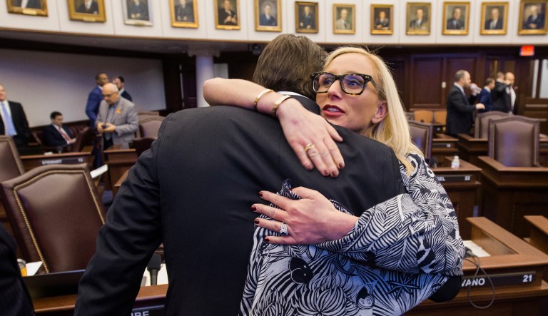 Florida Sen. Lauren Book, right, embraces Sen. Bill Galvano after Galvano's bill, the Marjory Stoneman Douglas High School Student Safety Act, passed 20-18 at the Florida Capitol in Tallahassee, Fla., Monday, March 5, 2018. (AP Photo/Mark Wallheiser)