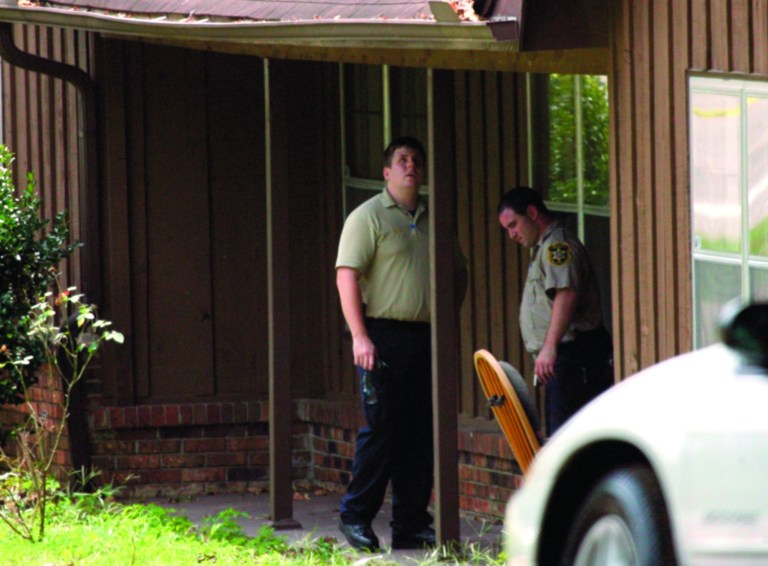 A crime scene unit investigates a home at 4106 4th Ave. East near Watermelon Road in Tuscaloosa, Ala., Tuesday, July 17, 2012 where a shooting on Monday injured one person, and allegedly lead to a related shooting early Tuesday that wounded nearly a dozen people, at a bar in Tuscaloosa. A gunman who fired into a crowded bar turned himself in Tuesday, several hours after the rampage, police said. Police have not identified him. (AP Photo/Tuscaloosa News, Dusty Compton)