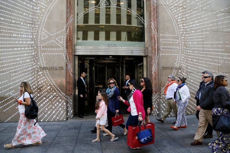 In this Monday, May 19, 2014 photo, shoppers walk by Tiffany & Company's Fifth Avenue store in New York. The upscale jeweler known for its blue boxes reports earnings Wednesday, May 21, 2014. (AP Photo/Mark Lennihan)