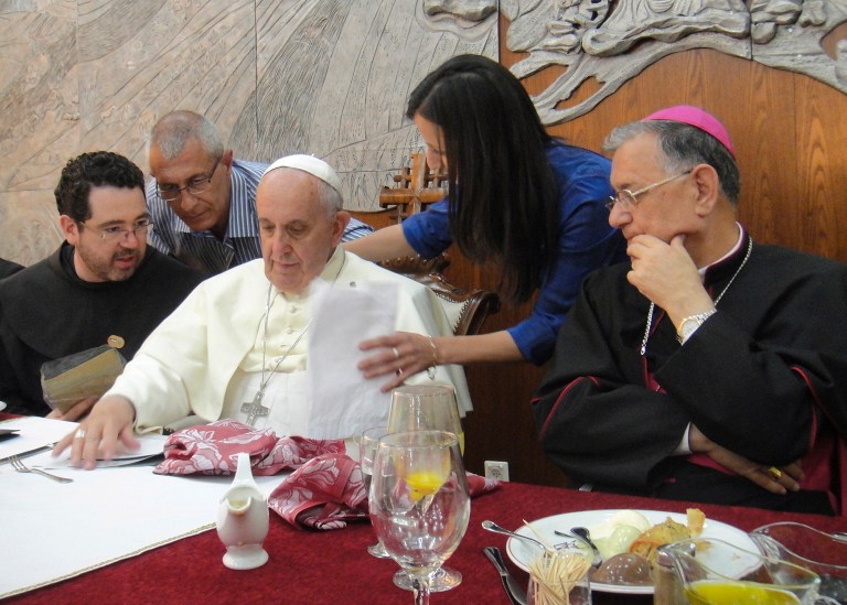 In this photo provided by the Palestinian Bannoura family, Juliette Bannoura, second right, meets Pope Francis in Bethlehem, West Bank, Sunday, May 25, 2014. Juliette Bannoura counts on Pope Francis to save her family's four acres of olive groves and the lands of other Palestinians in the scenic Cremisan Valley, near Jerusalem, from the destructive path of Israel's separation barrier. On the right is Latin Patriarch of Jerusalem Fouad Twal. (AP Photo/Bannoura family, HOEP)