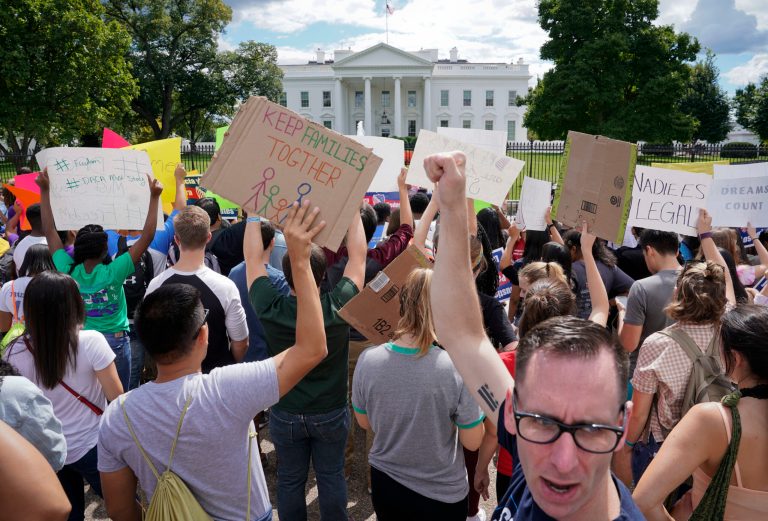 Malcolm McCluskey, right, pumps his fist in the air as he joins in a chant with supporters of Deferred Action for Childhood Arrival program (DACA) during a demonstration on Pennsylvania Avenue in front of the White House in Washington, Saturday, Sept. 9, 2017. President Donald Trump ordered and end of protections for young immigrants who were brought into the country illegally as children, but gave Congress six months to act on it. (AP Photo/Pablo Martinez Monsivais)