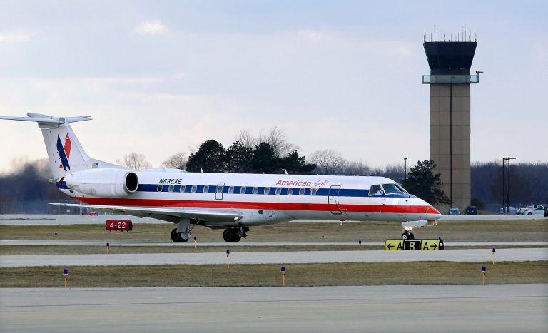 FILE - In this March 12, 2013 file photo, an American Eagle jet taxis to a gate past the control tower after landing at the Abraham Lincoln Capital Airport in Springfield, Ill. The regional airline industry may soon face the kind of consolidation that thinned the ranks of the largest airlines from eight between 2008 and the end of 2013. (AP Photo/Seth Perlman, File)