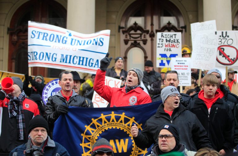 This Dec. 11, 2012 file photo shows some of the thousands that gathered for a rally protest against the passage of right-to-work legislation outside the State Capitol in Lansing, Mich. (AP Photo/Carlos Osorio, File)