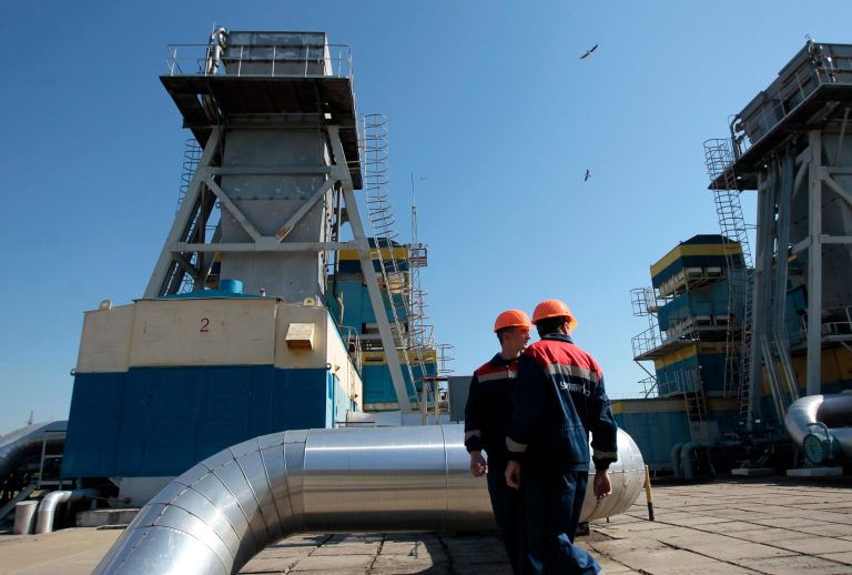 FILE - In this Wednesday May 21, 2014 file photo, gas pipeline station workers walk past the gas pressure engines in Zakarpattia region, Western Ukraine, 15 kms on border with Slovakia in Uzhgorod, Ukraine. Russia on Monday, June 16, 2014, cut gas supplies to Ukraine as a payment deadline passed and negotiators failed to reach a deal on gas prices and unpaid bills amid continued fighting in eastern Ukraine. The decision does not immediately affect the gas flow to Europe, but could disrupt the long-term energy supply to the region if the issue is not resolved, analysts said. (AP Photo/Sergei Chuzavkov, file)