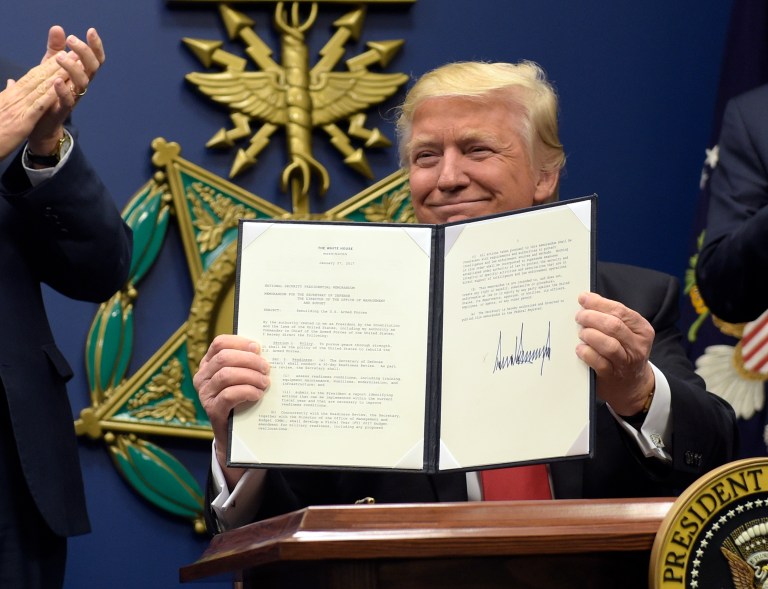 President Donald Trump shows his signature on an executive action on rebuilding the military during an event at the Pentagon in Washington, Friday, Jan. 27, 2017. (AP Photo/Susan Walsh)