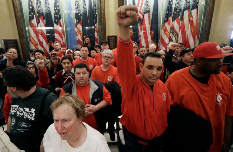   Protesters gather for a rally in the rotunda at the State Capitol in Lansing, Mich., Tuesday, Dec. 11, 2012. The crowd is protesting right-to-work legislation passed last week. Michigan could become the 24th state with a right-to-work law next week. Rules required a five-day wait before the House and Senate vote on each other's bills; lawmakers are scheduled to reconvene Tuesday and Gov. Snyder has pledged to sign the bills into law. (AP Photo/Paul Sancya)  