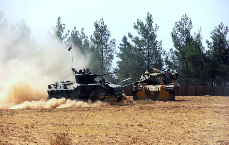 Turkey sent tanks and special forces into Syria on Wednesday to help clear a border town of Islamic State militants, marking the NATO member's most significant military involvement so far in the Syria conflict. (IHA via AP)