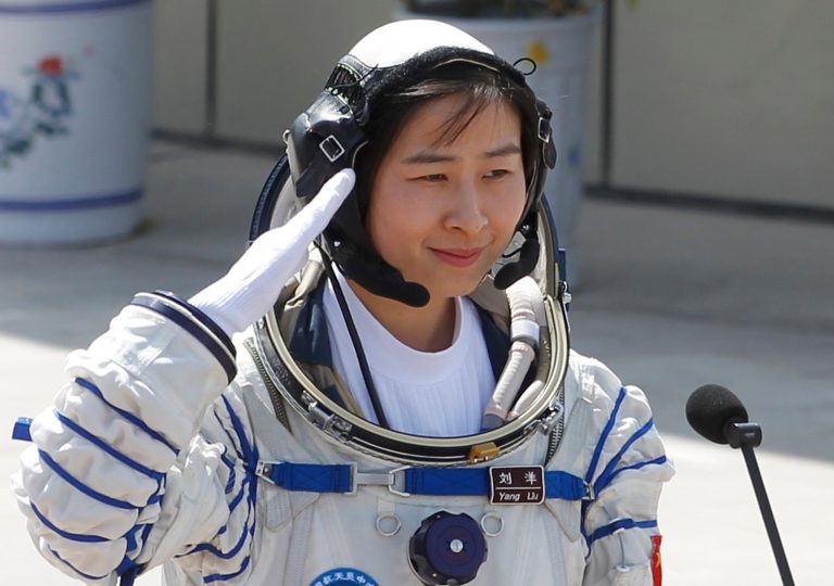   China's first female astronaut Liu Yang salutes during a sending off ceremony as she departs for the Shenzhou 9 spacecraft rocket launch pad at the Jiuquan Satellite Launch Center in Jiuquan, China, Saturday, June 16, 2012. China will send its first woman and two other astronauts into space Saturday to work on a temporary space station for about a week, in a key step toward becoming only the third nation to set up a permanent base in orbit.(AP Photo/Ng Han Guan)  