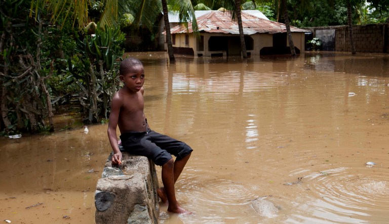 A boy sits on wall near his home flooded by heavy rains brought on by Hurricane Irma, in Fort-Liberte, Haiti, om Friday. Irma is expected to make landfall in Florida this weekend. ( AP Photo/Dieu Nalio Chery)