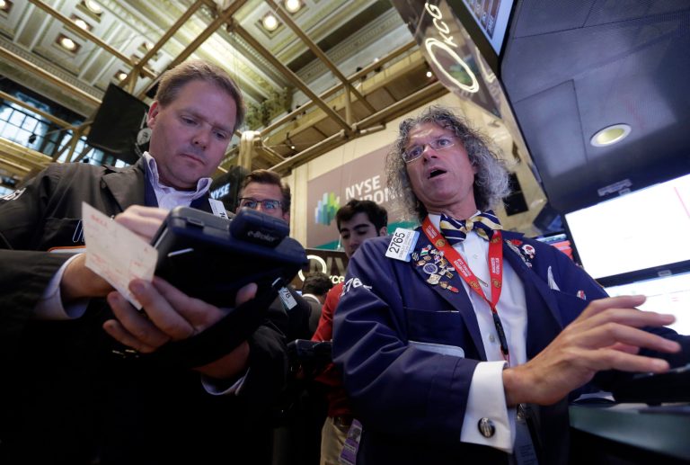 Trader Thomas McCauley, left, and specialist Donald Civitanova work on the floor of the New York Stock Exchange, Friday, May 23, 2014. Stocks inched higher early Friday in quiet trading ahead of the Memorial Day weekend.  (AP Photo/Richard Drew)