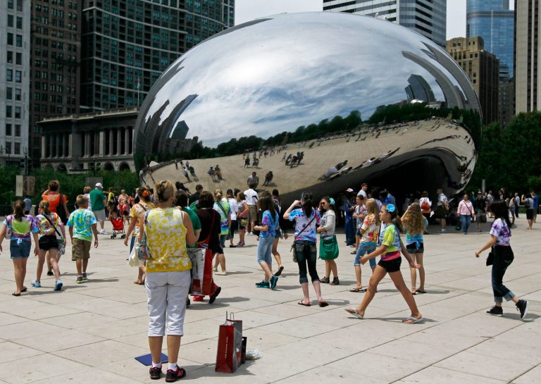   In this Wednesday, June 13, 2012, photo, visitors at Chicago's Millennium Park enjoy the sculpture 