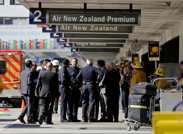 LosÃÂ AngelesÃÂ Police Chief Charlie Beck talks with other responders atÃÂ LosÃÂ AngelesÃÂ InternationalÃÂ Airport on Friday. (AP Photo/Reed Saxon)