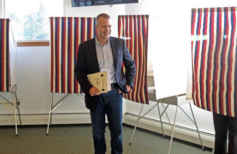 Dan Sullivan, candidate for the Reublican nomination for election to the U.S. Senate, leaves the voting booth after marking his ballot in Alaska's primary election in Anchorage, Tuesday, Aug. 19, 2014. (AP Photo/Becky Bohrer)