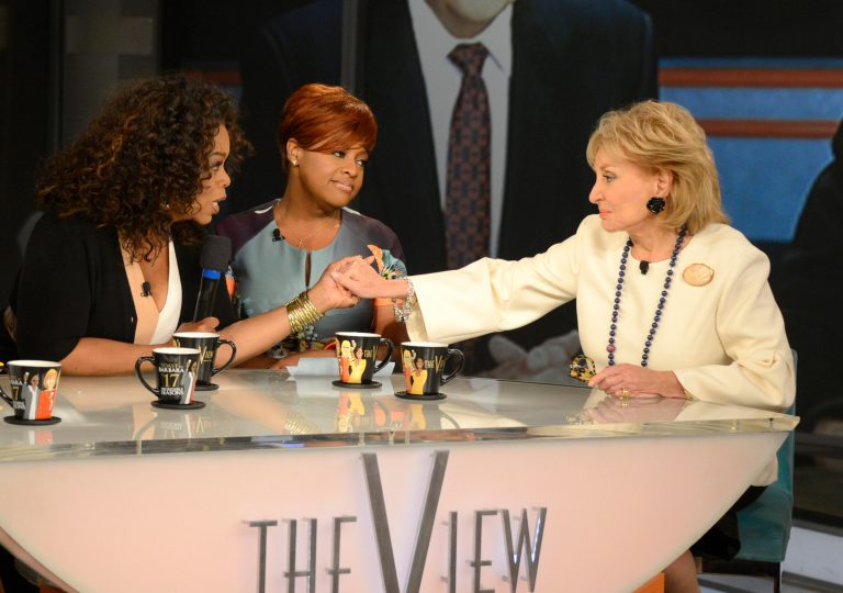 This Thursday, May 15, 2014 photo released by ABC shows, Oprah Winfrey, left, grasping hands with Barbara Walters, right, as co-host Sherri Shepherd looks on during a taping of Walters' final co-host appearance on 