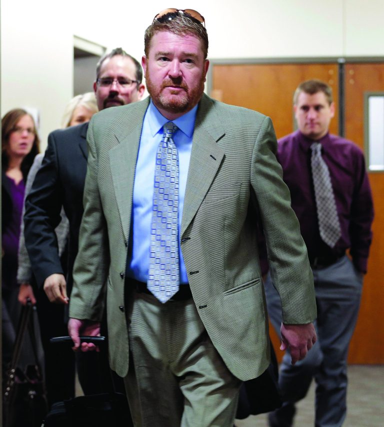 Defense attorney Daniel King leads his team to court for the third day of a preliminary hearing for Aurora theater shooting suspect James Holmes at the courthouse in Centennial, Colo., on Wednesday, Jan. 9, 2013. (AP Photo/Ed Andrieski)